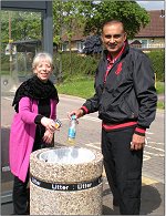 Vanessa McPake and Subhan Shafiq use the new litter bin by the bus shelter at Dunchurch Dale, Walnut Tree